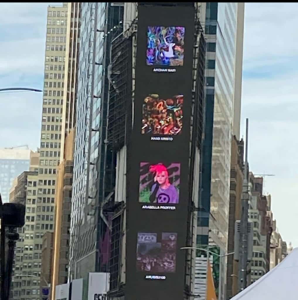Digital billboard in Times Square, New York City, showing stacked NFT artworks including Hans Kristo’s piece among other international artists.