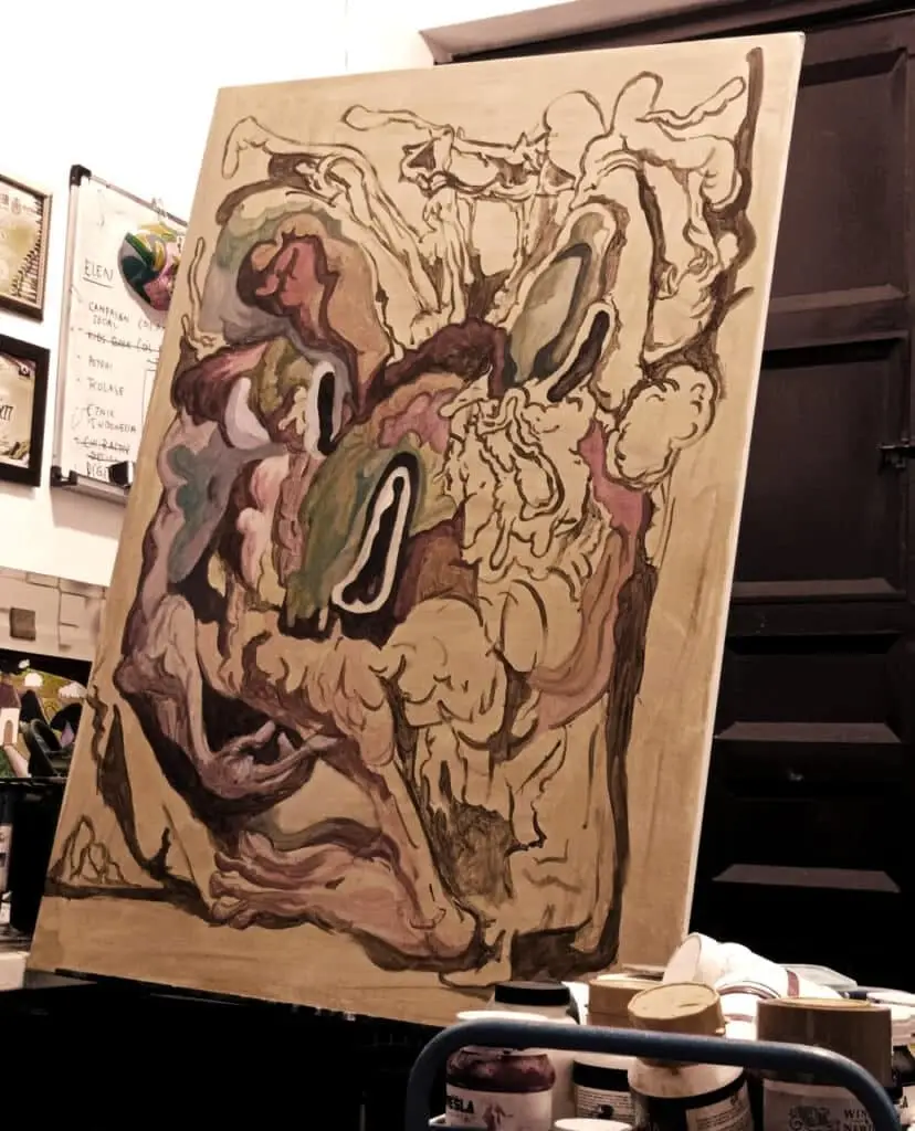 An abstract painting with fluid, organic shapes in earthy tones, displayed on an easel in a studio, inviting deep interpretation in art through its distorted, biomorphic forms.