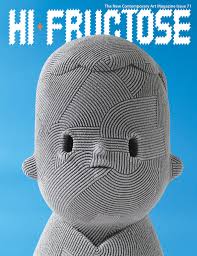 The cover of HI-FRUCTOSE magazine Issue 71 against a solid blue background. The main visual is a close-up photograph of a stylized, grey sculptural bust with features entirely defined by precisely arranged, concentric and parallel ridges of textured thread, creating a tactile and rhythmic pattern. The figure has dark slit eyes and a forward-facing pose. The magazine title is in large, stylized white capital letters at the top.