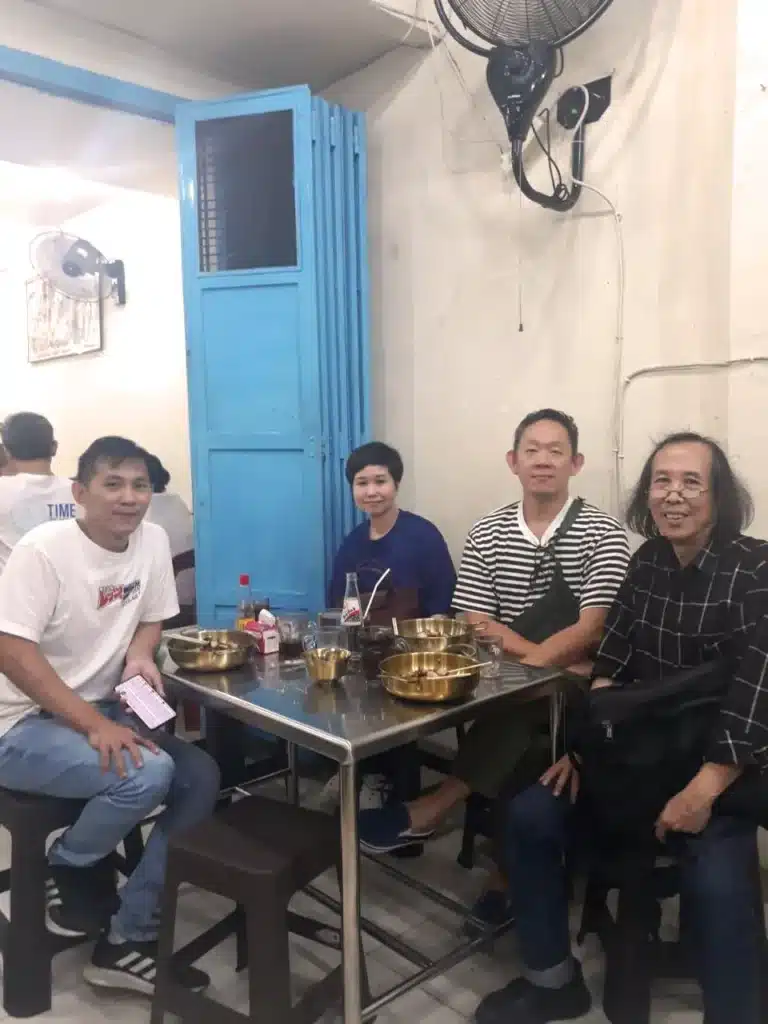 Artist Hans Kristo, artist and art collector Franky Pandana with his wife, and senior contemporary art curator Hendro Wiyanto sitting together at a local eatery during a curatorial visit to Medan.