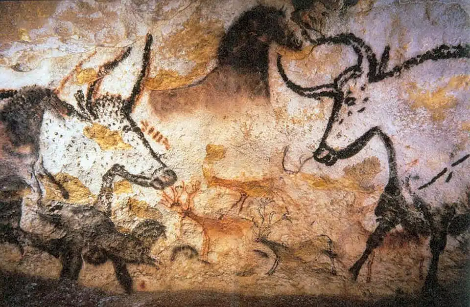 Prehistoric cave paintings of ancient cattle and stags in Lascaux Cave France highlighting prehistoric art evolution.
