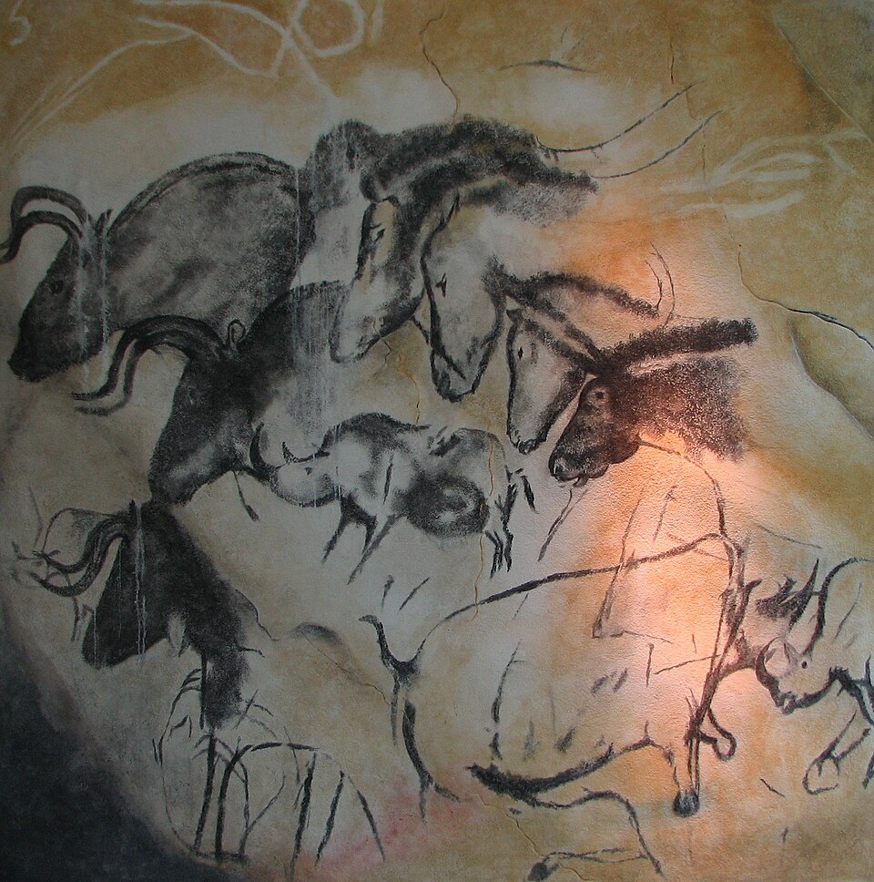 Prehistoric cave paintings of cave lions and rhinoceroses in Chauvet Cave France showcasing advanced shading and prehistoric art evolution.