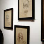 8 Captivating and Powerful Reasons Young Art Collectors Are Transforming the Art World — From Pop Surrealism to AI Art 15 Pop Surrealism skeletal celebrity drawings framed on exhibition wall at Corey Helford Gallery.