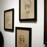8 Captivating and Powerful Reasons Young Art Collectors Are Transforming the Art World — From Pop Surrealism to AI Art 15 Pop Surrealism skeletal celebrity drawings framed on exhibition wall at Corey Helford Gallery.